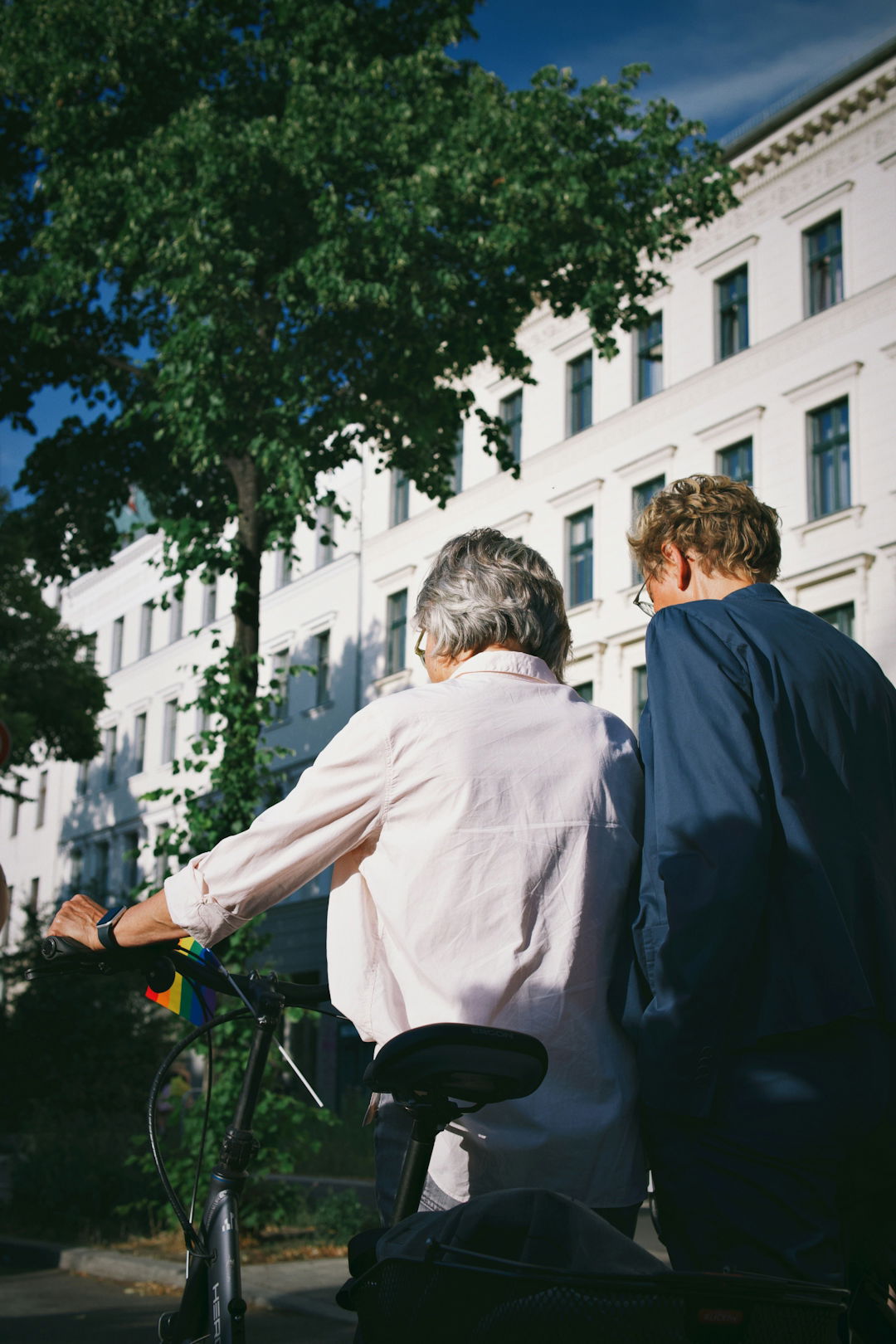 a-man-and-a-woman-riding-a-bike-down-a-street.jpg a man and a woman riding a bike down a street
